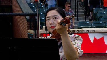 Dr. Hyejin Kim plays both national anthems on violin
