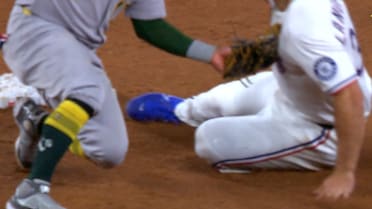 Luis Urías nabs the runner after a review