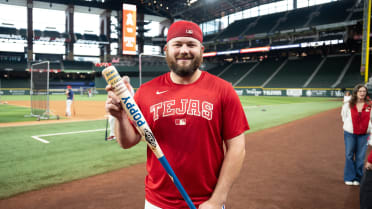 Jake Burger shows off custom bat