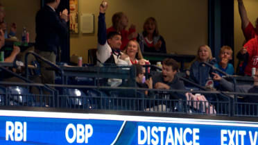 Fan catches foul ball while holding baby