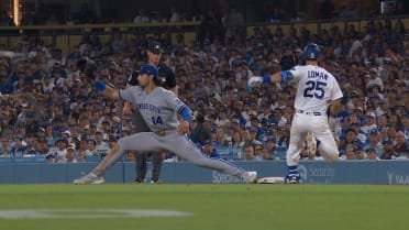 Tommy Edman safe at first after challenge