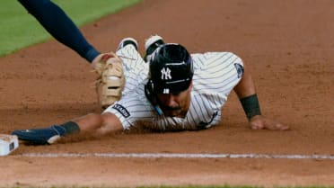 Trent Grisham safe at first after a review