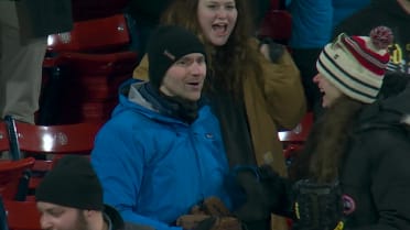 A fan catches two foul balls at Fenway Park