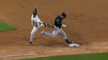 Tim Tawa is safe at first after review