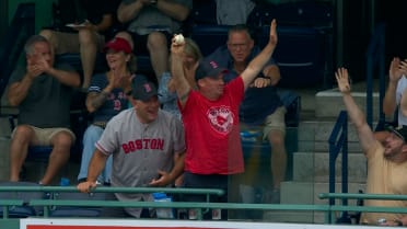 A fan catches a foul ball at Fenway Park
