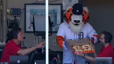 PAWS the tiger delivers pizza to the Angels booth