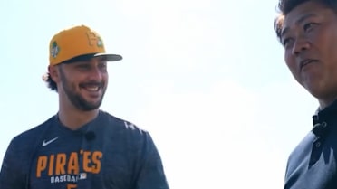 Paul Skenes signs a hat for Daisuke Matsuzaka