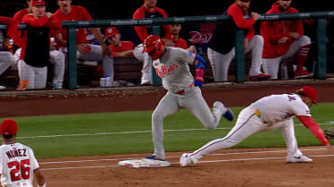 Edmundo Sosa reaches first base after challenge