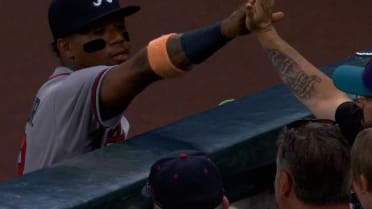 Ronald Acuña Jr. high-fives fan after catch