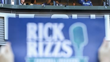 Rick Rizzs smiles down to fans cheering for him