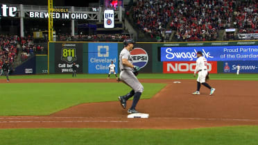 Giancarlo Stanton touches first base after a review