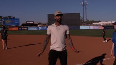Byron Buxton coaches first base during softball game