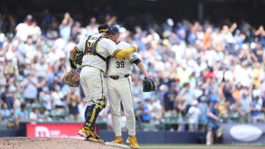 Brewers turn double play to secure win after review