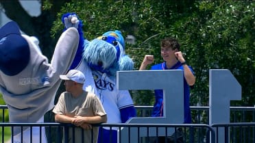 A fan makes a great catch and celebrates with Raymond