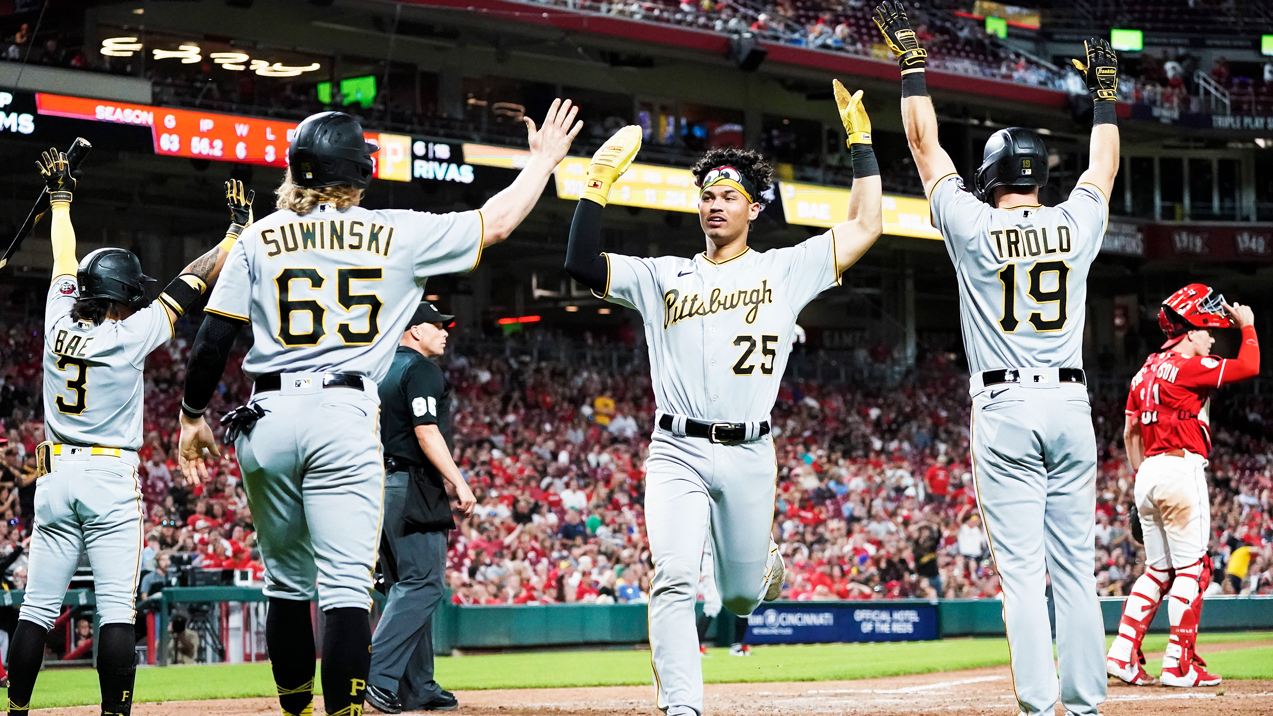 Pirates players celebrate after erasing a 9-0 deficit in Cincinnati