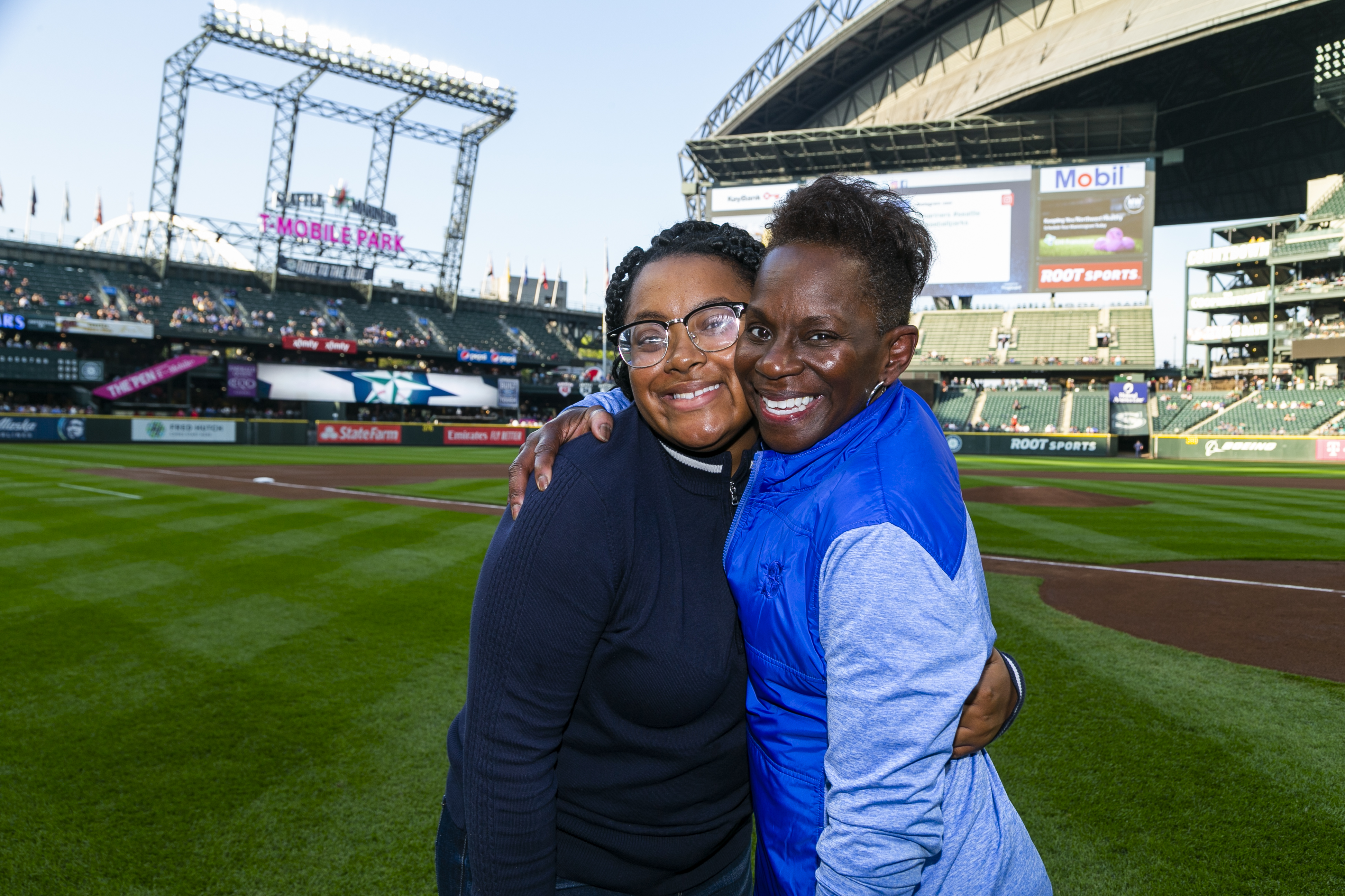 Ingrid Russell-Narcisse and her daughter, Aliyah Narcisse, pose for a photo after Ingrid threw out the first pitch at Women in Baseball Day.