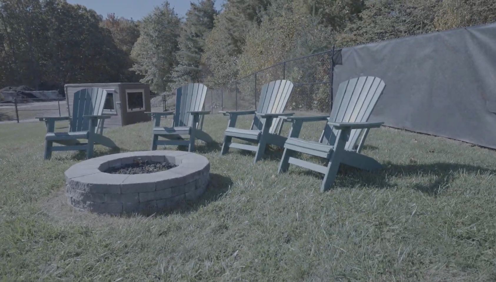 Adirondack chairs and a fire pit along the first-base line at Beaver Field
