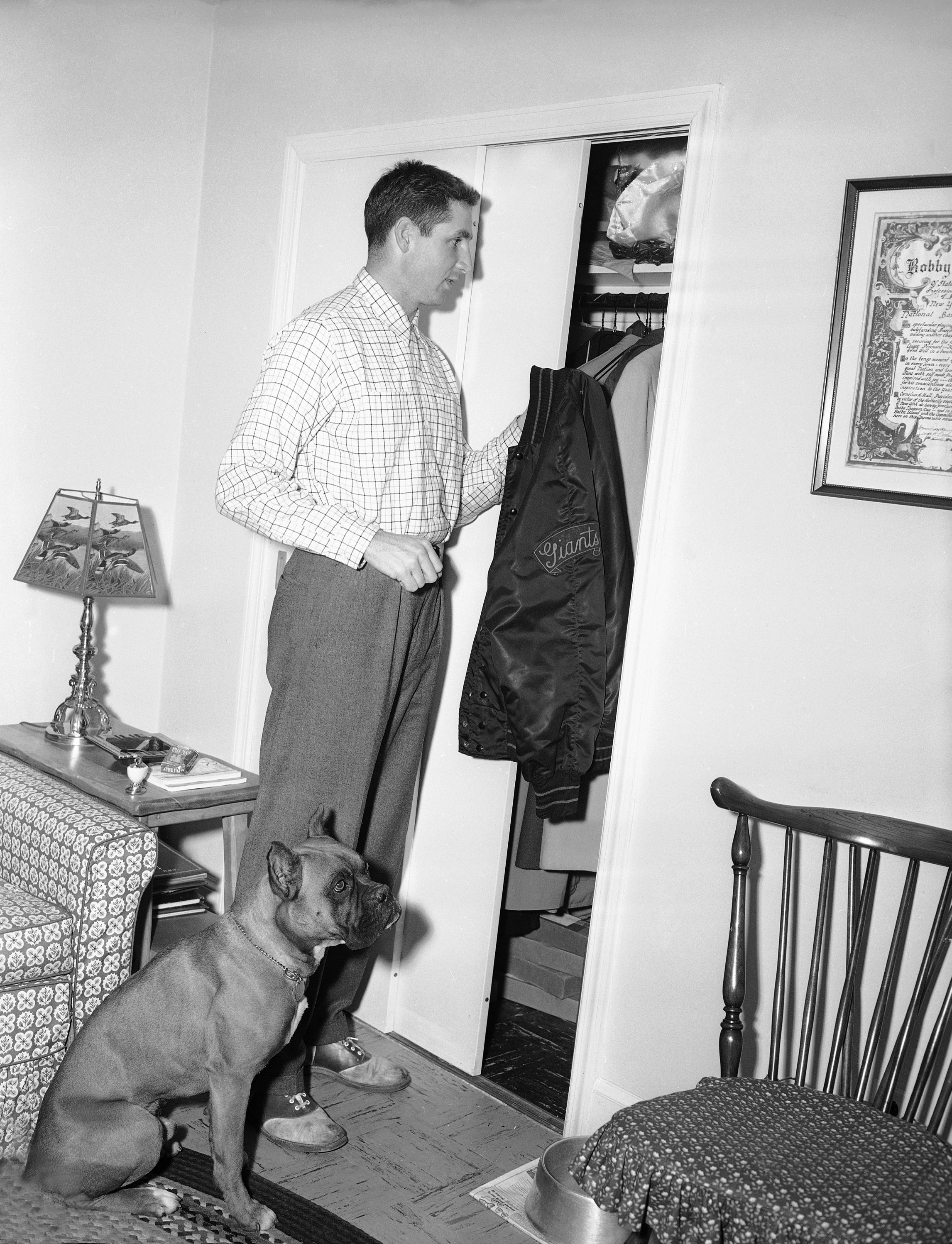 Bobby Thomson in his Staten Island home with his Boxer, Major, in 1954.