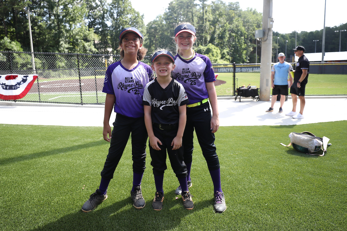 Ellery Thomas (r.) with some teammates in front of the new Rhyne Park softball fields (Photo by Mady Mertens/MLB Photos via Getty Images)