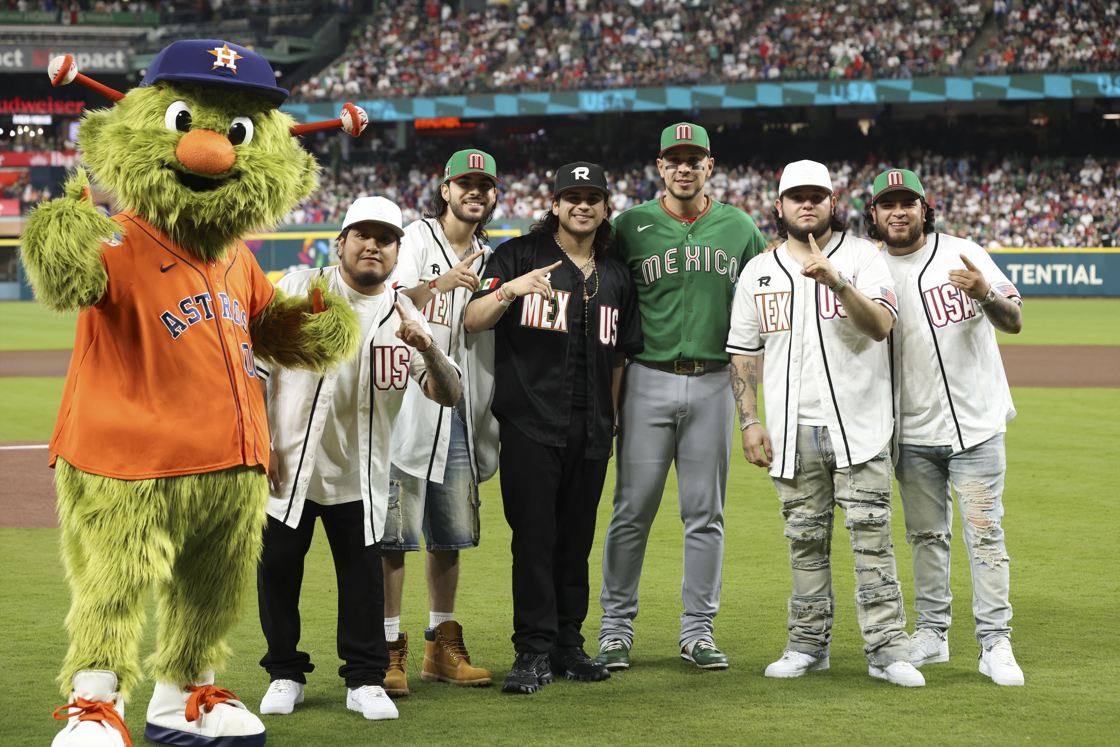 Fuerza Regida before throwing out a first pitch in Houston at the World Baseball Classic.