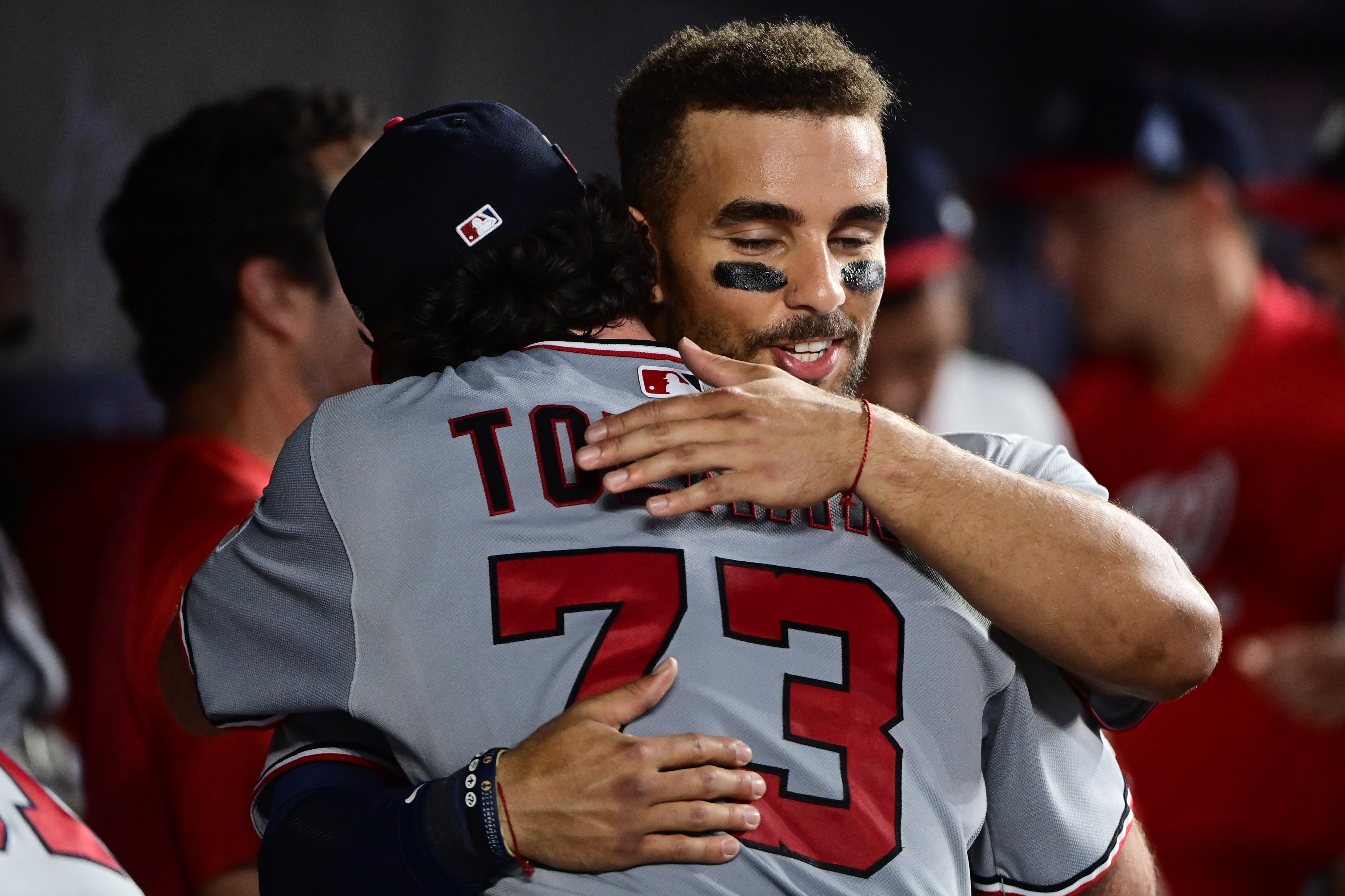 Erik Tolman hugging catcher Harry Ford in the dugout after his MLB debut on Saturday.