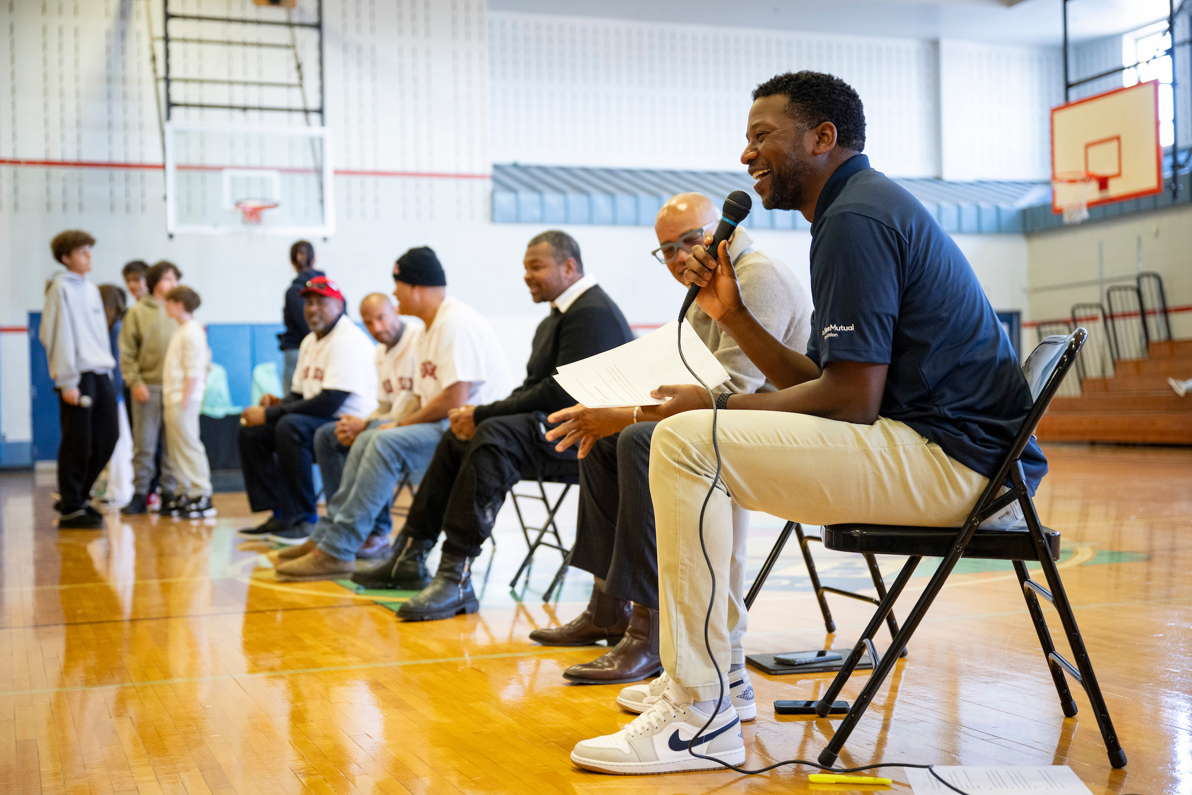Jahmai Webster, Red Sox sideline reporter for NESN, holding mic.