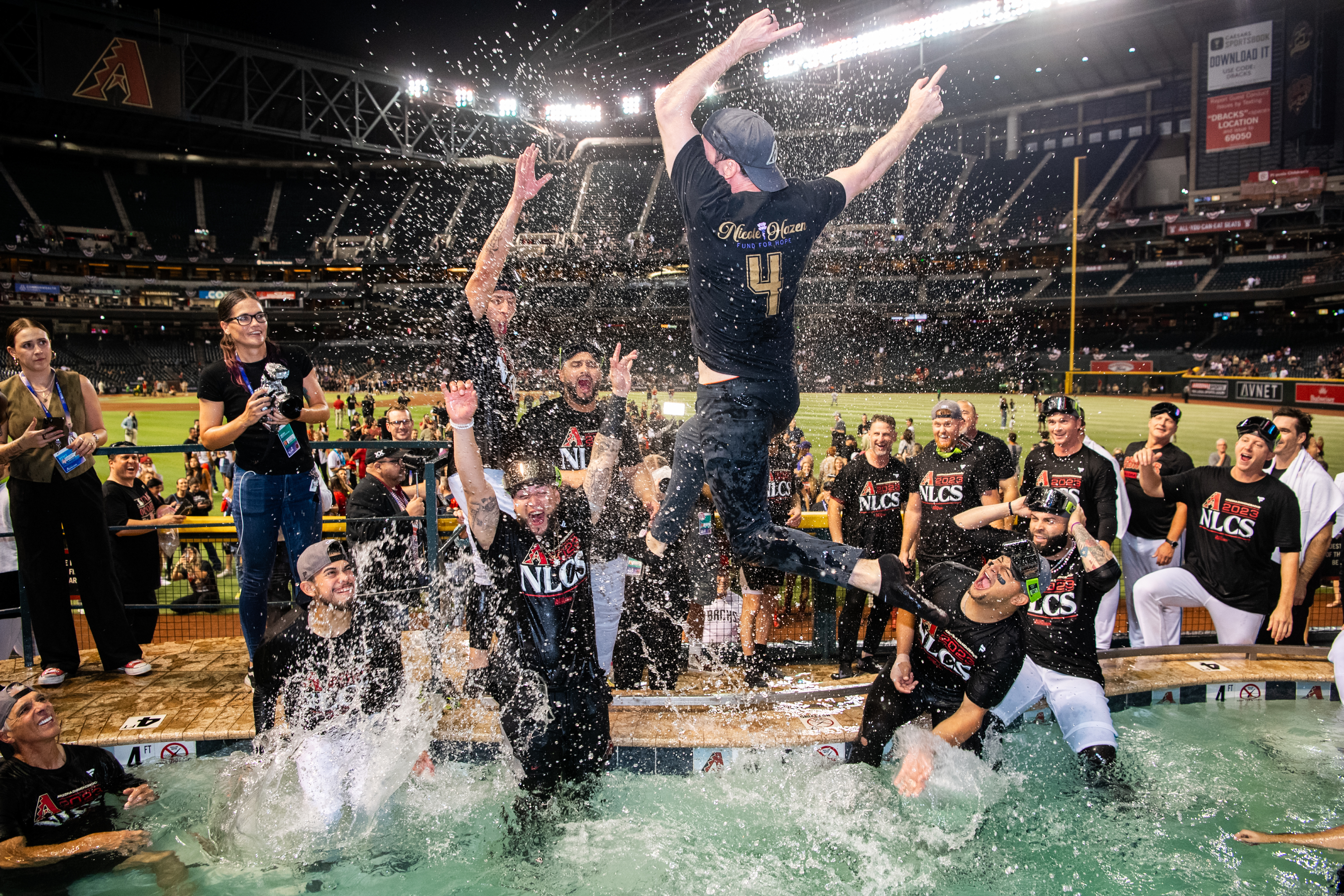 Mike Hazen leaps into the D-backs' pool after the club's 2023 NLDS win. (Credit: Hazen family)