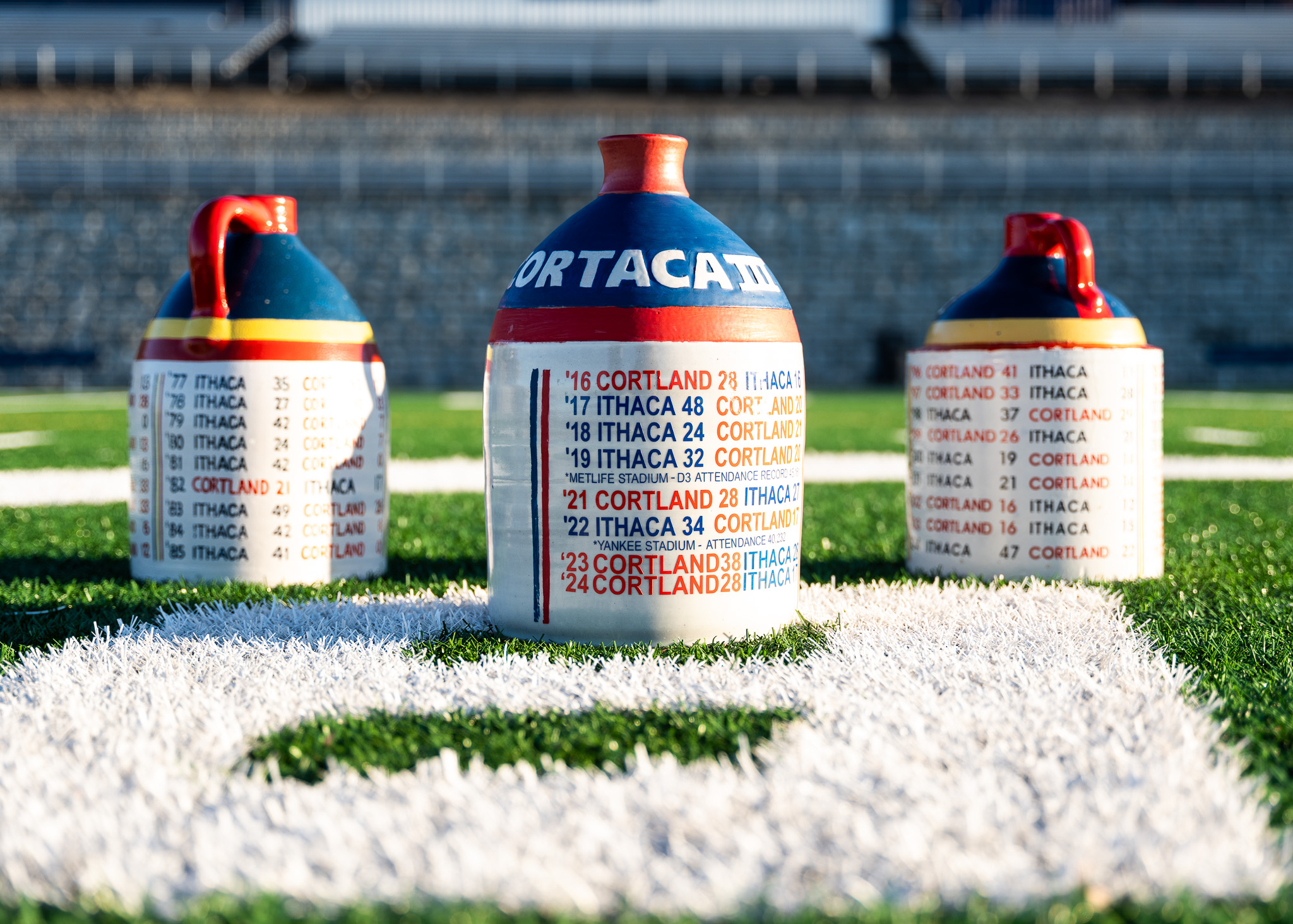 The Cortaca Jug was introduced in 1959 to honor a rivalry first contested 29 years earlier. The original $2 jug became a coveted trophy passed back and forth between the winner of the annual game. Today, there are three jugs to account for the number of meetings between the teams, and they make for quite a recruiting pitch for the winner. (Photo Credit: Ithaca College Athletics)