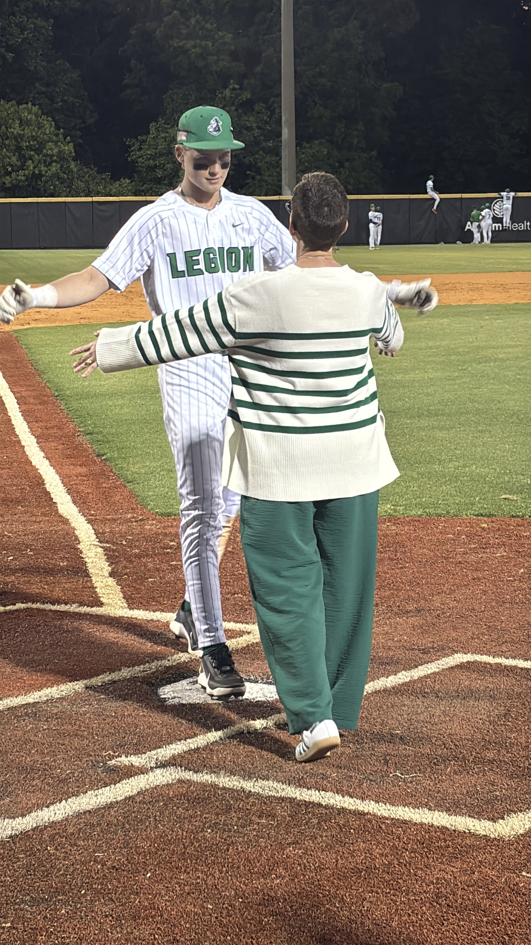 Lancers senior Parker McGee embraces his mom, Angie, at home plate (Photo by Anthony Castrovince)