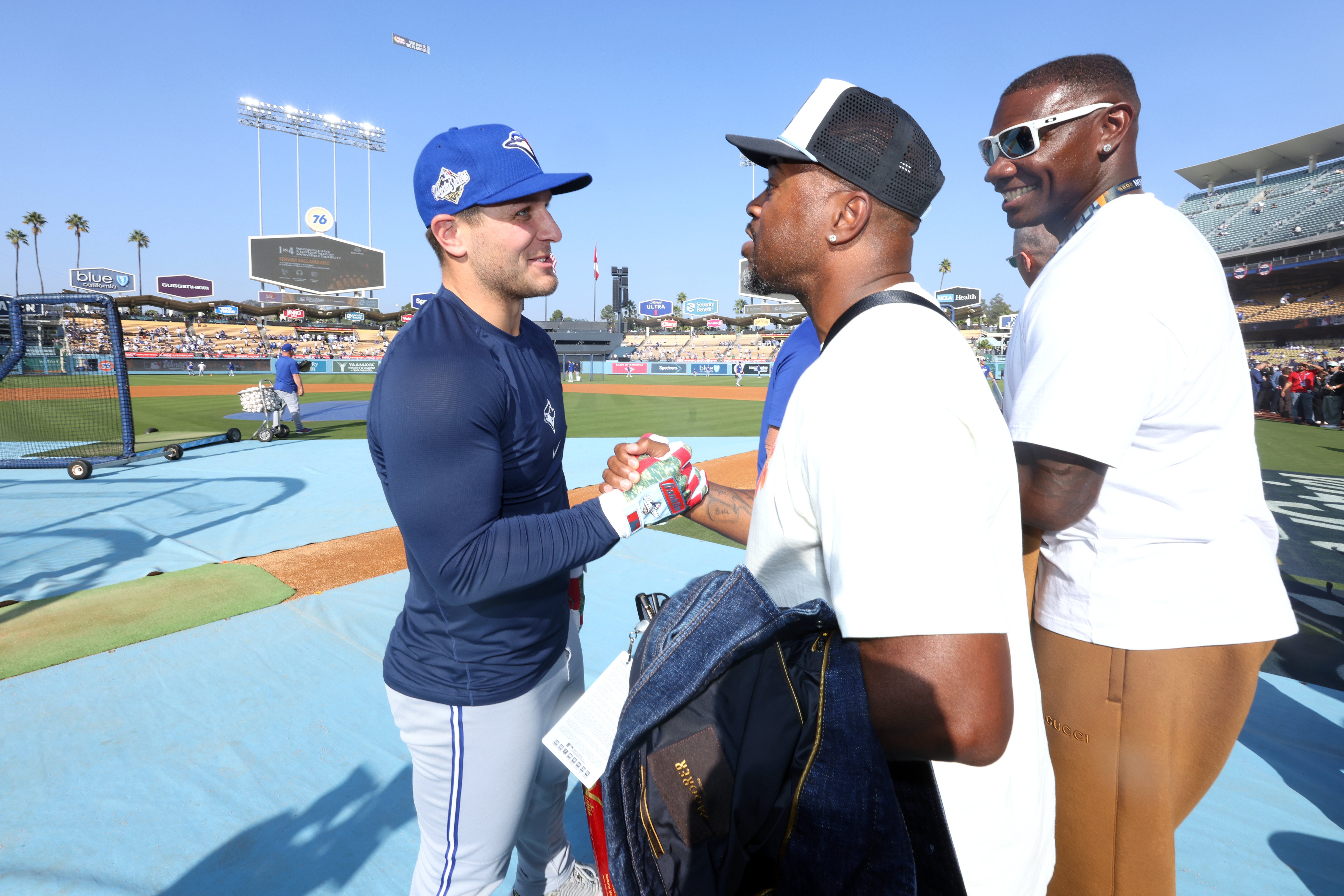 Daulton Varsho meets with Jimmy Rollins and Ryan Howard ahead of Game 3 of the 2025 World Series.
