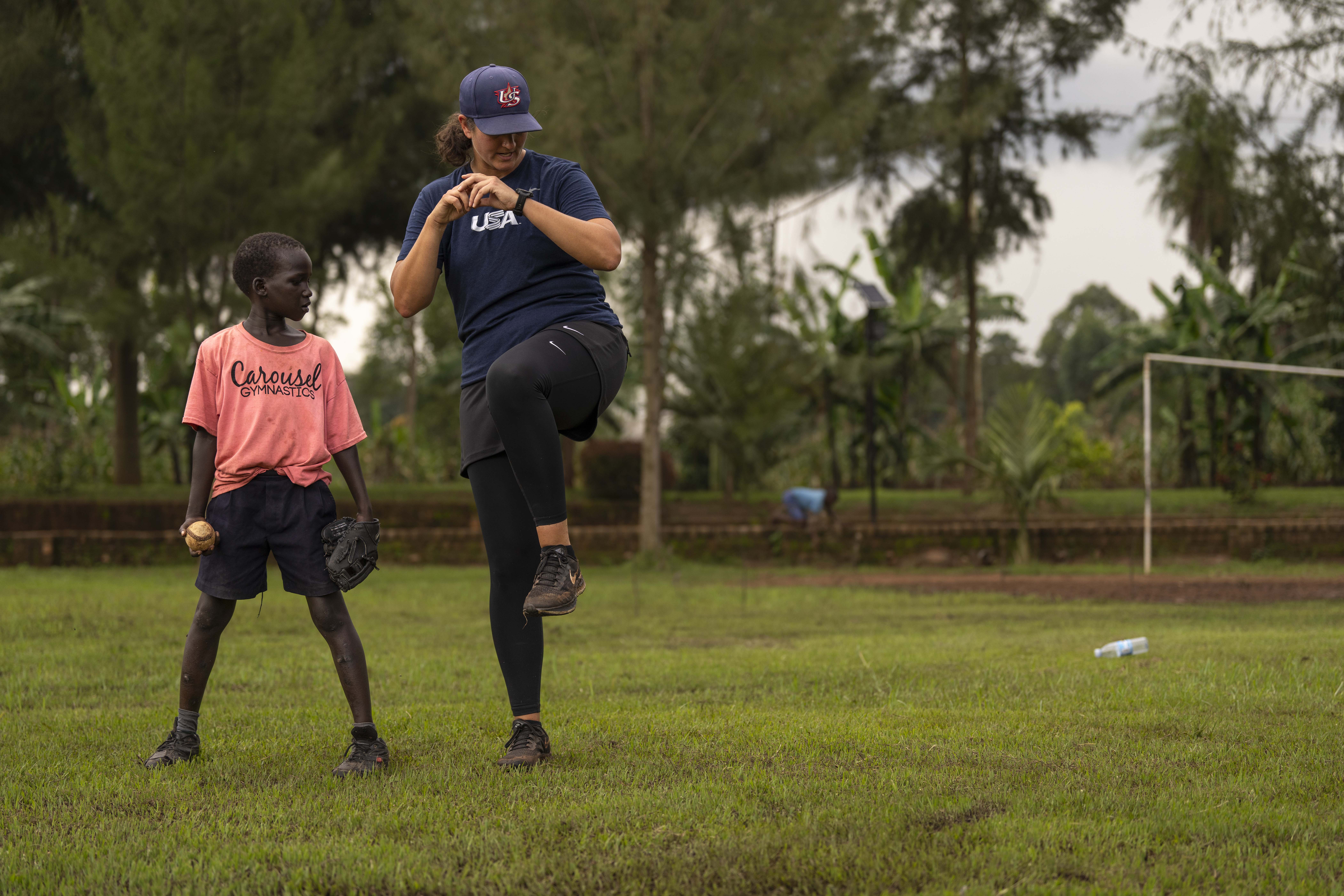 Meidlinger shows a young player how to pitch. Photo by Jean Fruth.