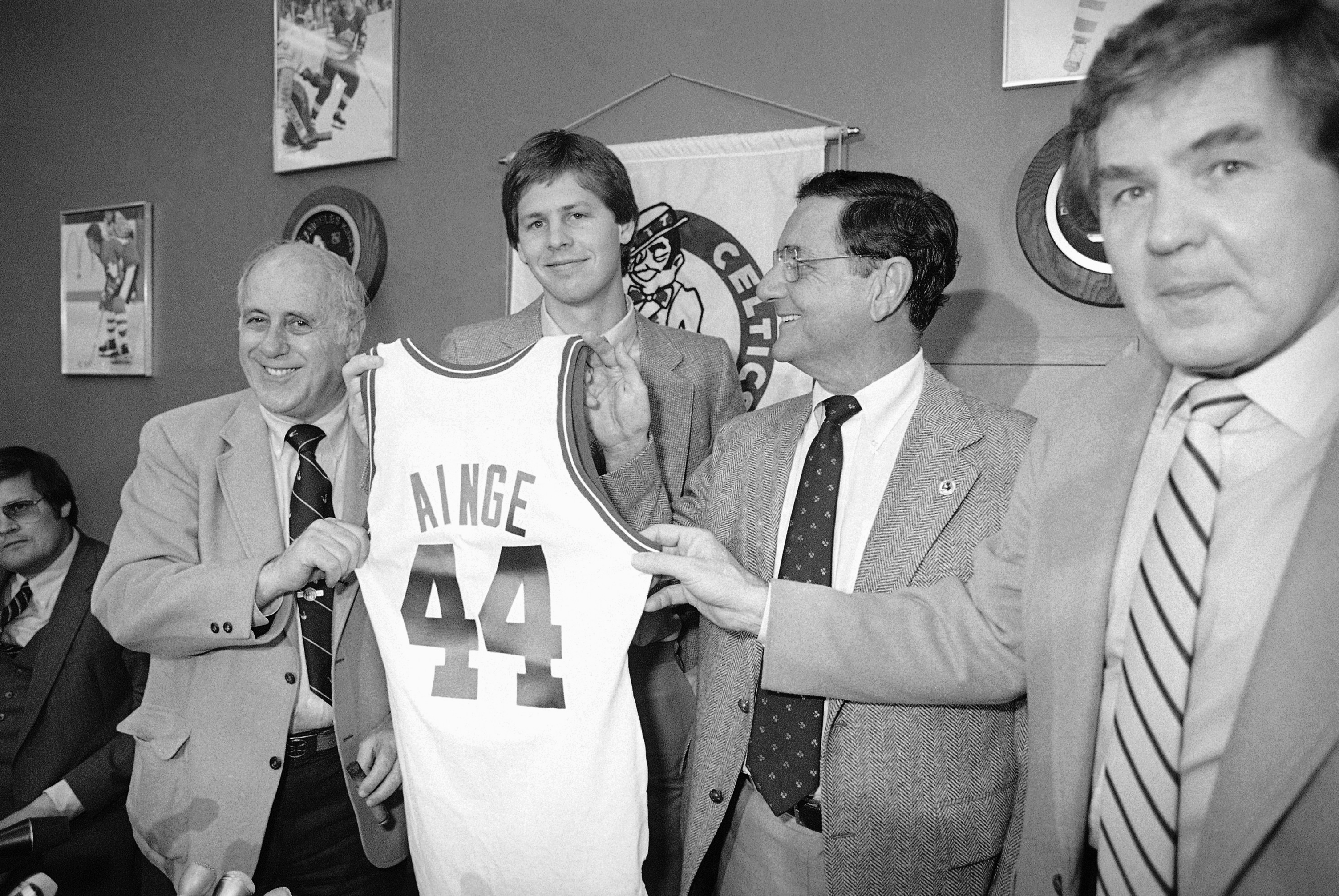 Ainge (center, holding jersey) with Celtics GM Red Auerbach (left) and owner Harry Mangurian (right). (AP)