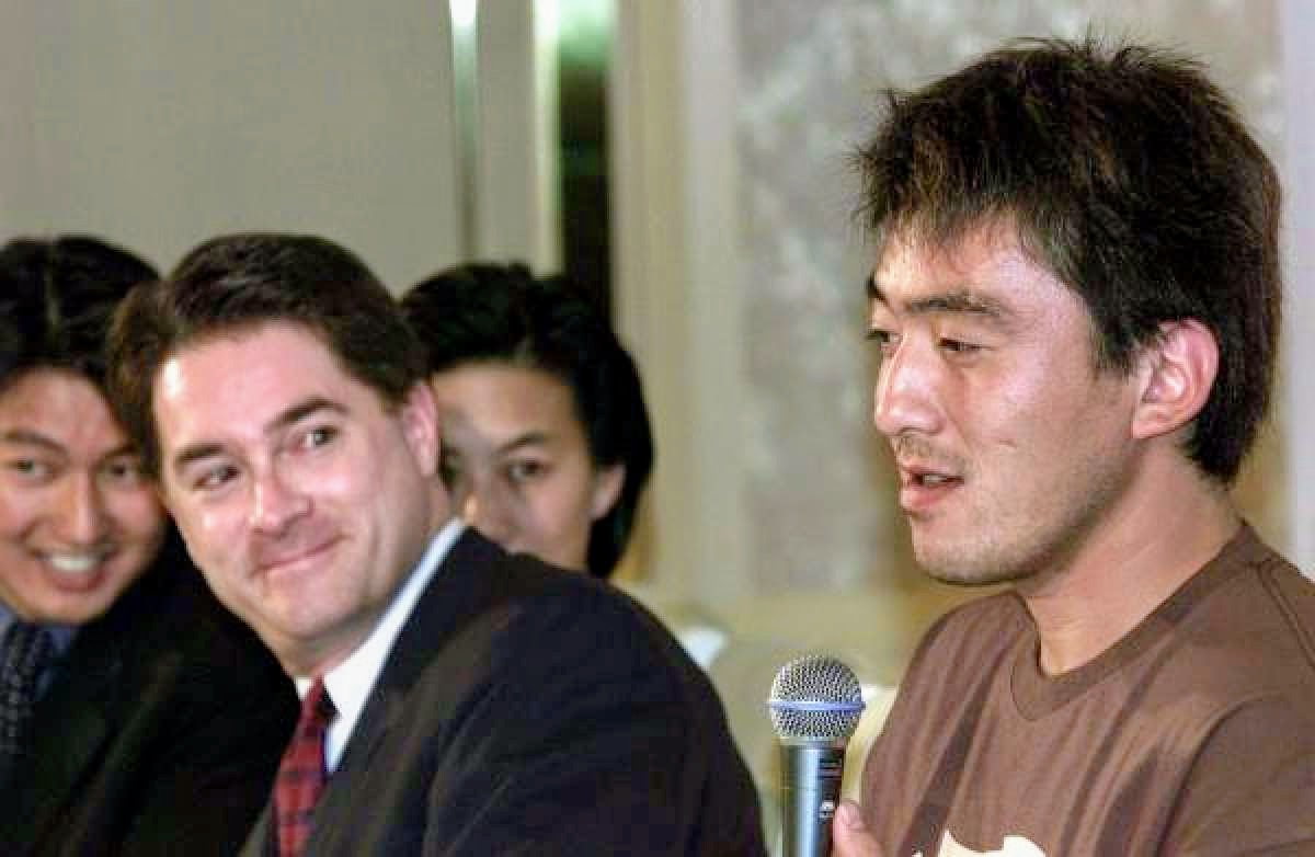 Dan Evans (with Acey Kohrogi and Kim Ng in the background) at the press conference announcing Kazuhisa Ishii's signing.