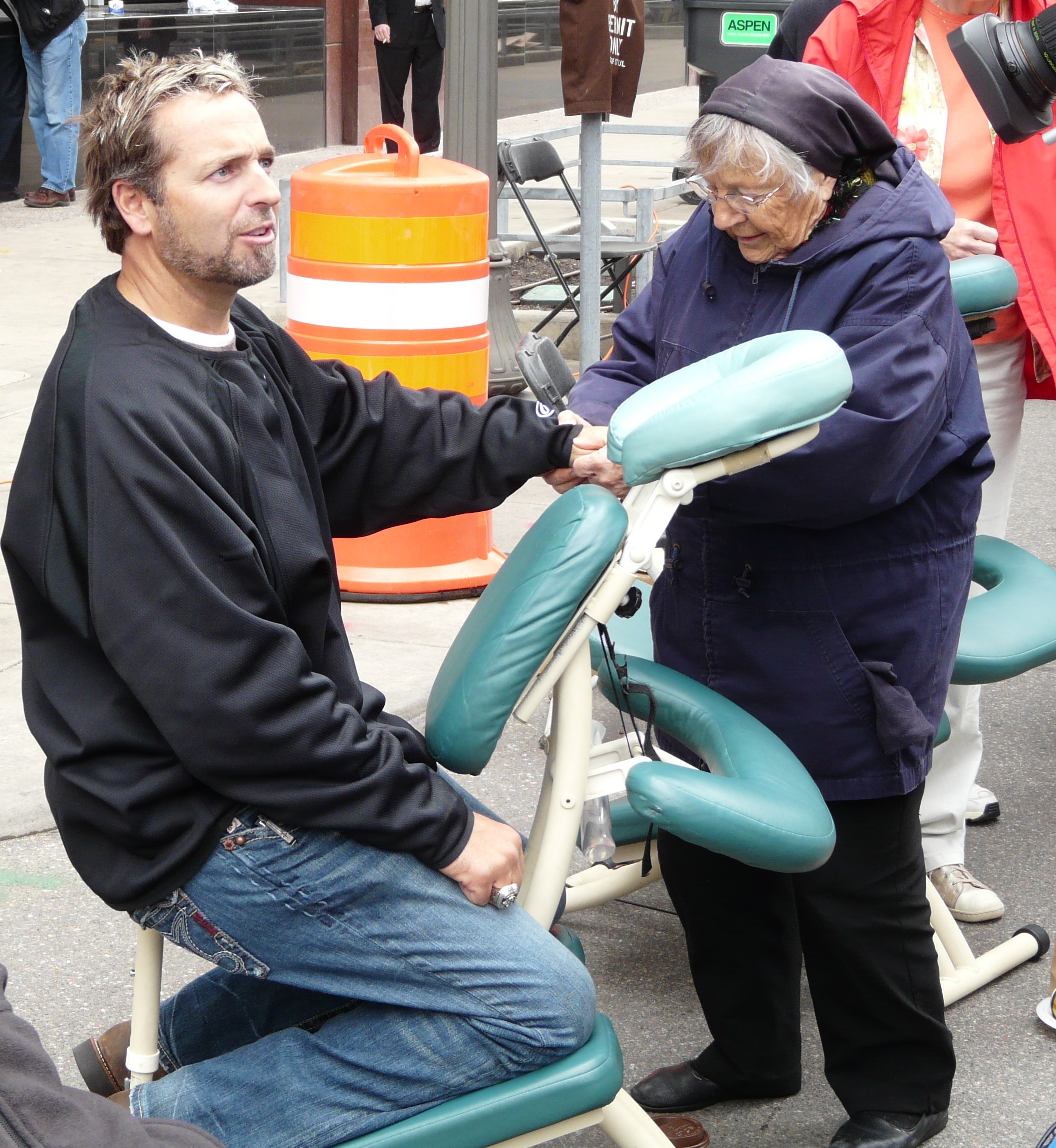 Sister Ros gives a massage to former Saints player Kevin Millar.