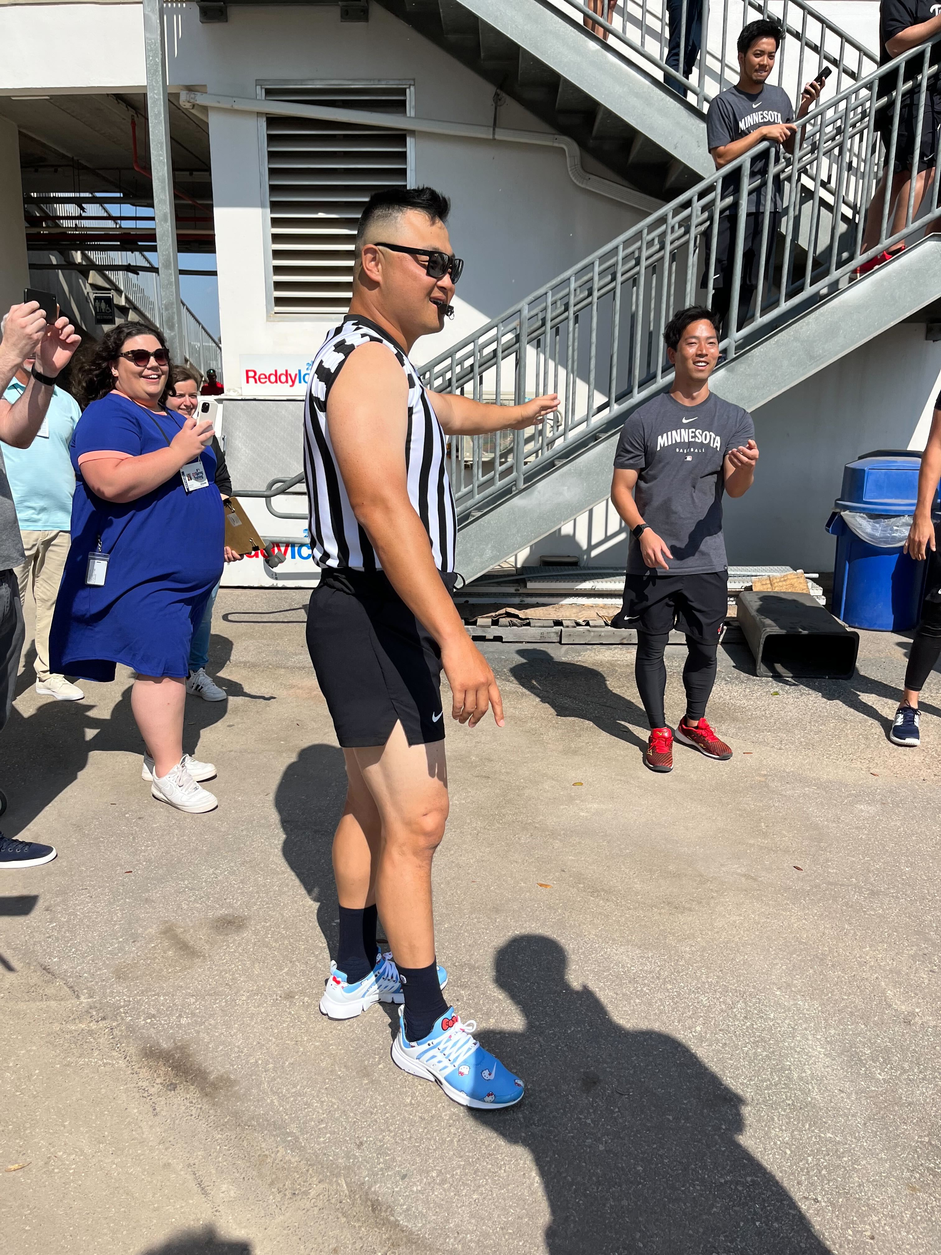 Twins first-base coach Hank Conger refereeing an egg toss competition