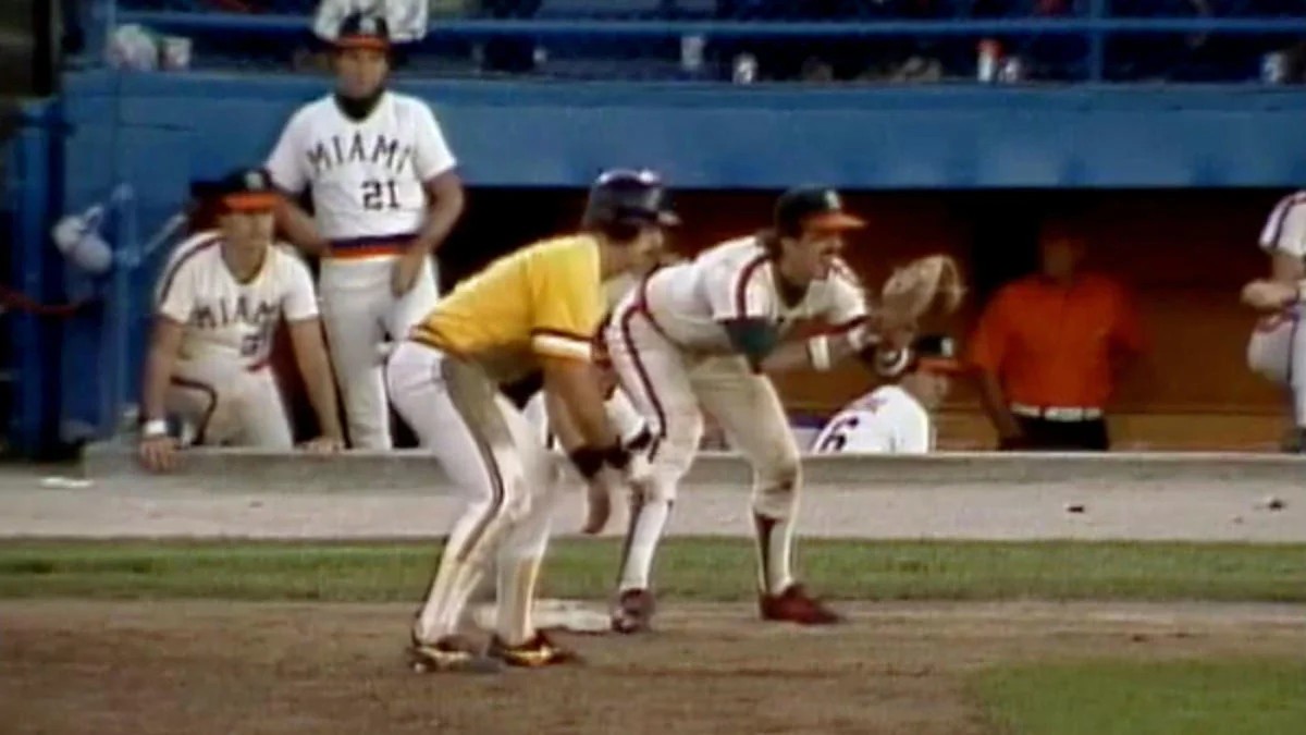 Wichita State's Phil Stephenson being held at first base by Miami's Steve Lusby just before the trick play was executed.