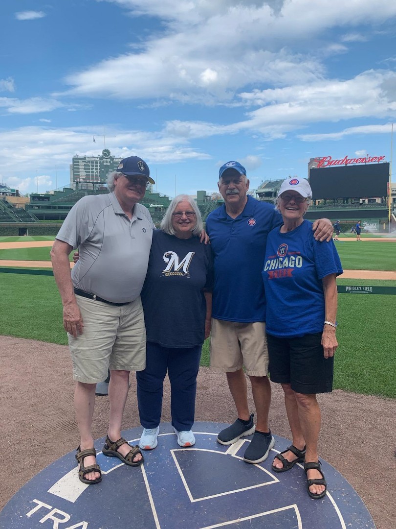 Tom and Trici Schraeder (left) with Jim Saletta and his girlfriend, Sandra Schuessler, at Wrigley Field in 2022.