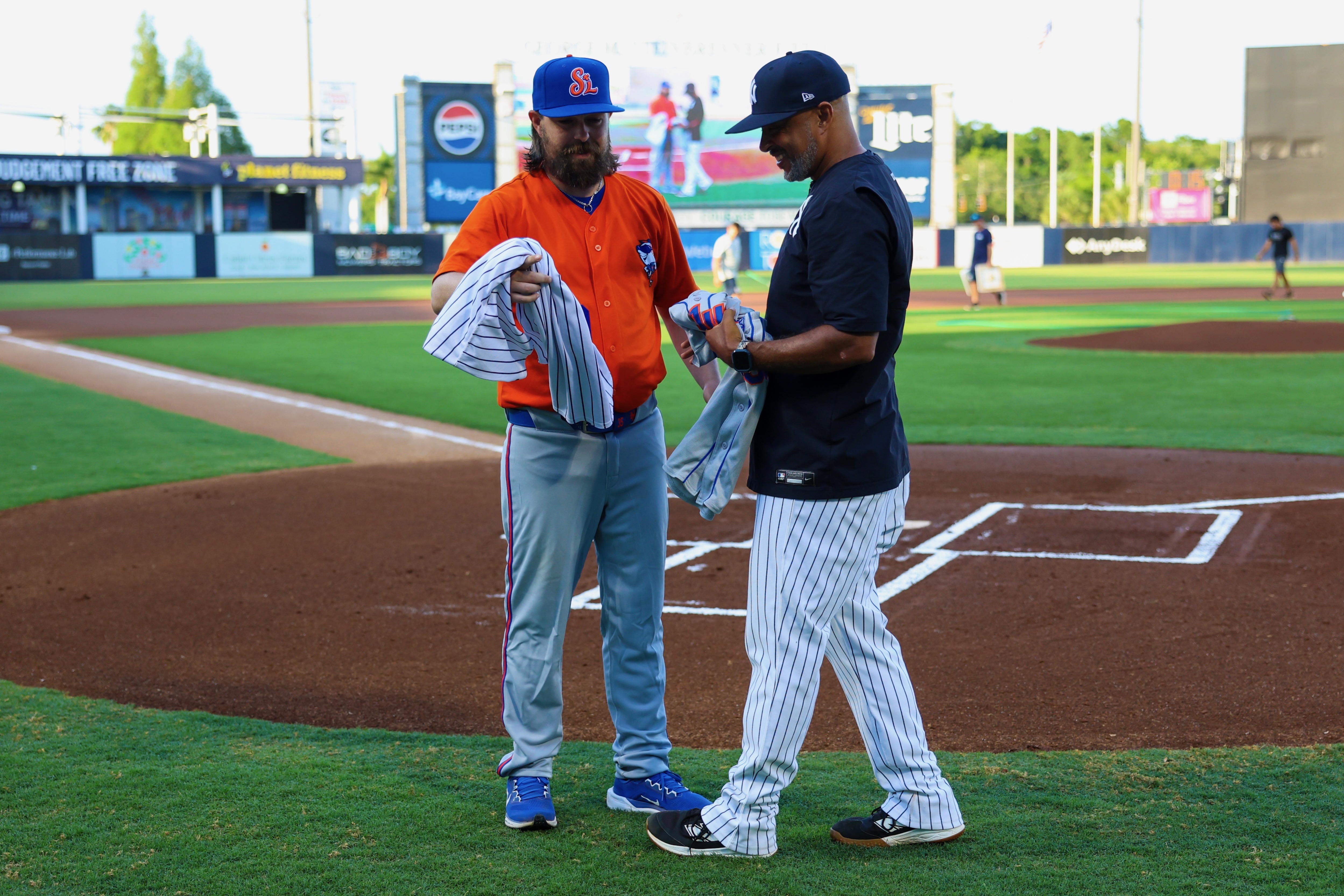 Jonathon Cramman (left) and Drew Spencer exchanging jerseys before the Mets-Tarpons doubleheader.