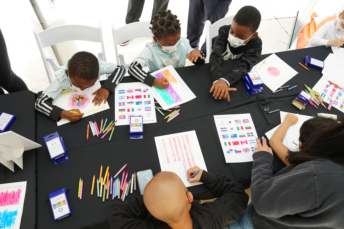 Kids at Alex's Place colored flags representing the teams in the World Baseball Classic.