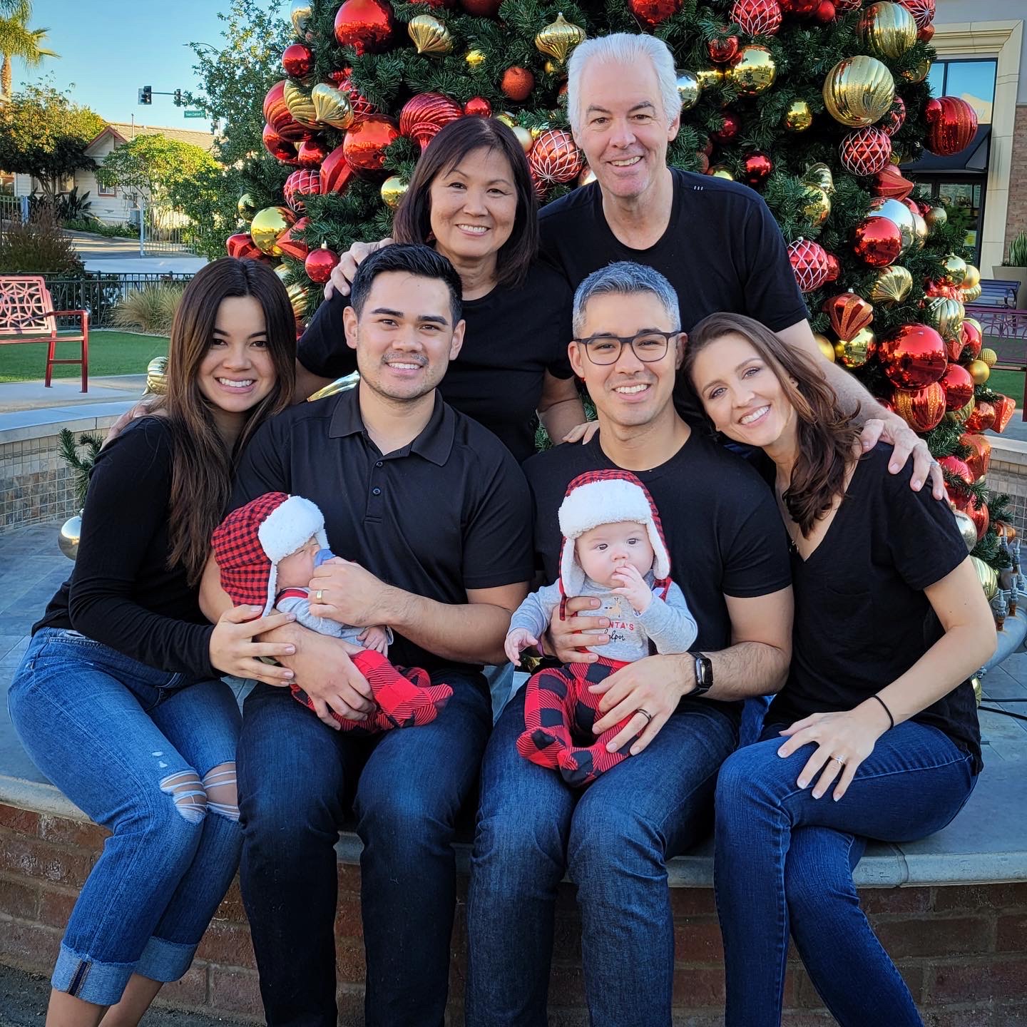 Seated in the front row: Stephen’s little sister, Kimi, Matt (brother-in-law) holding Luca, Stephen holding Kai and his wife, Cori. In the back are Stephen's parents, Flo and Scott.