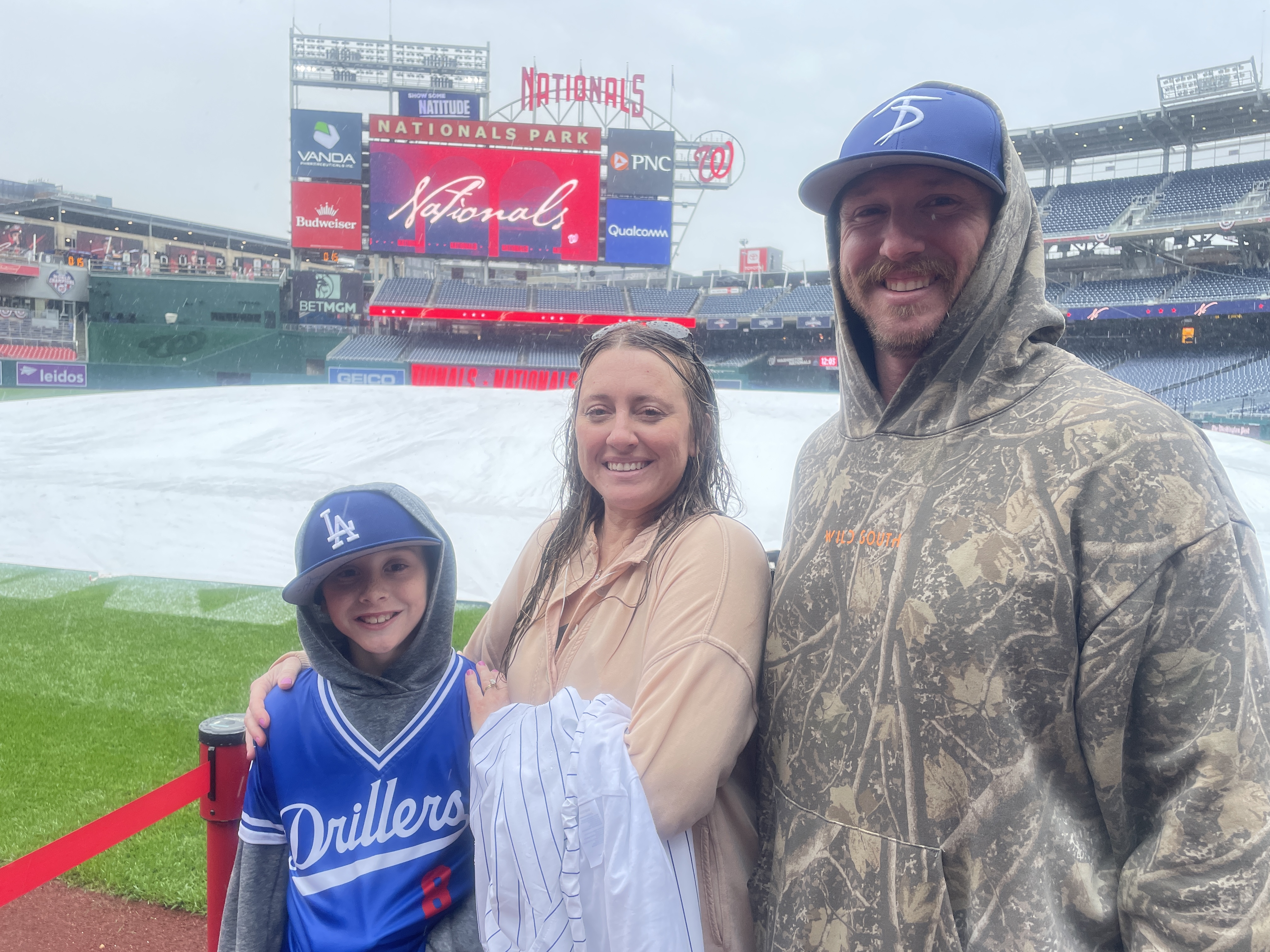 Cochrane family waits in the rain. Photo by Ayako Oikawa.
