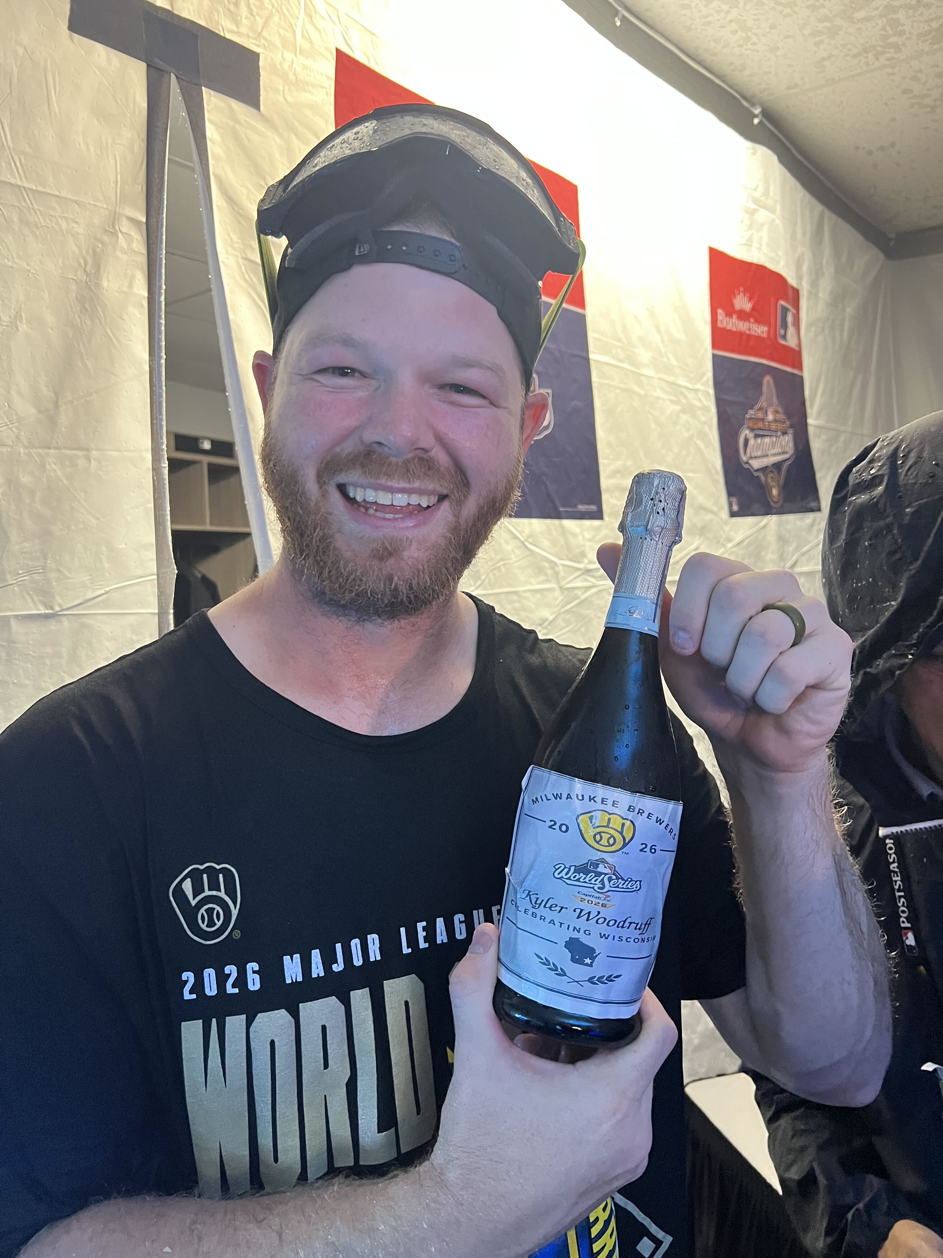 Brandon Woodruff celebrates with a bottle of champagne boasting the name of his daughter, Kyler. (photo via Adam McCalvy)