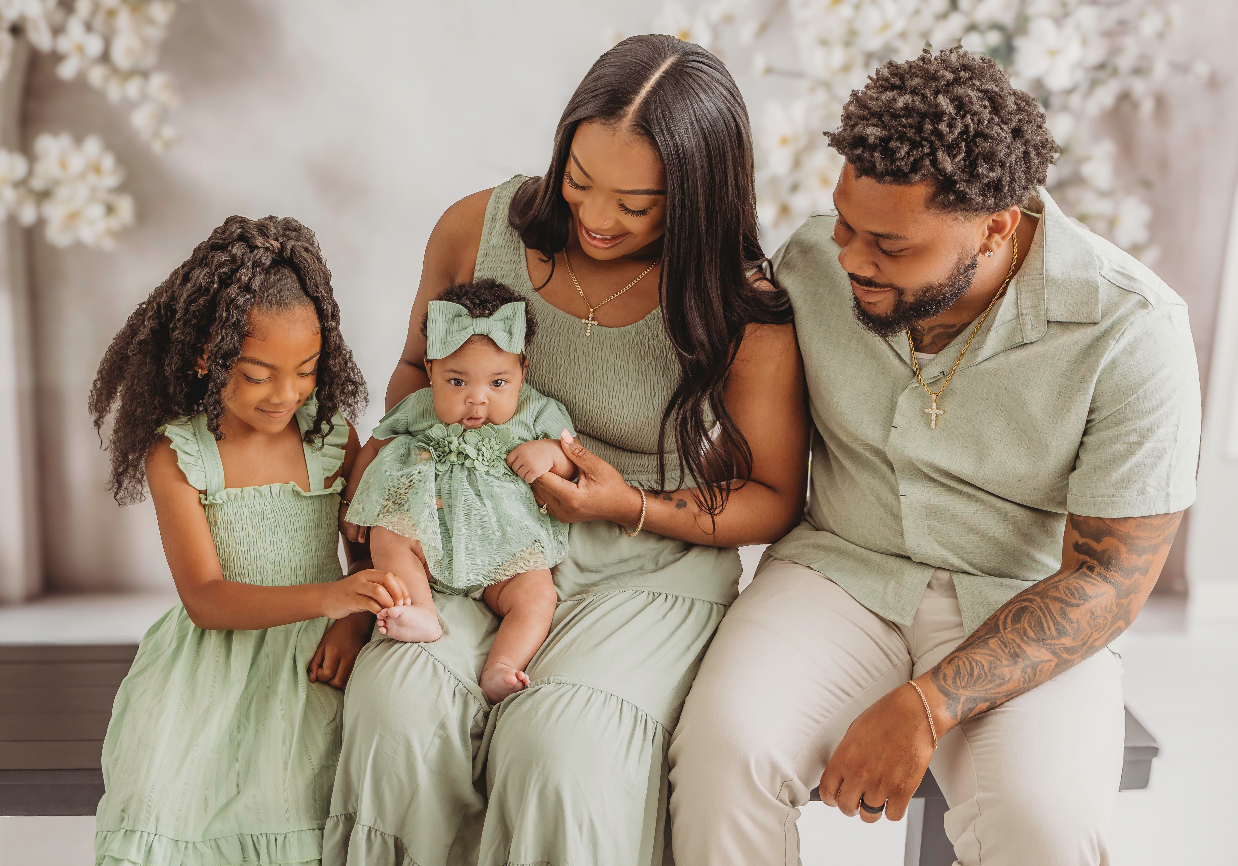Odicci Alexander-Bennett with her stepdaughter, baby Halo and husband Hakeem.