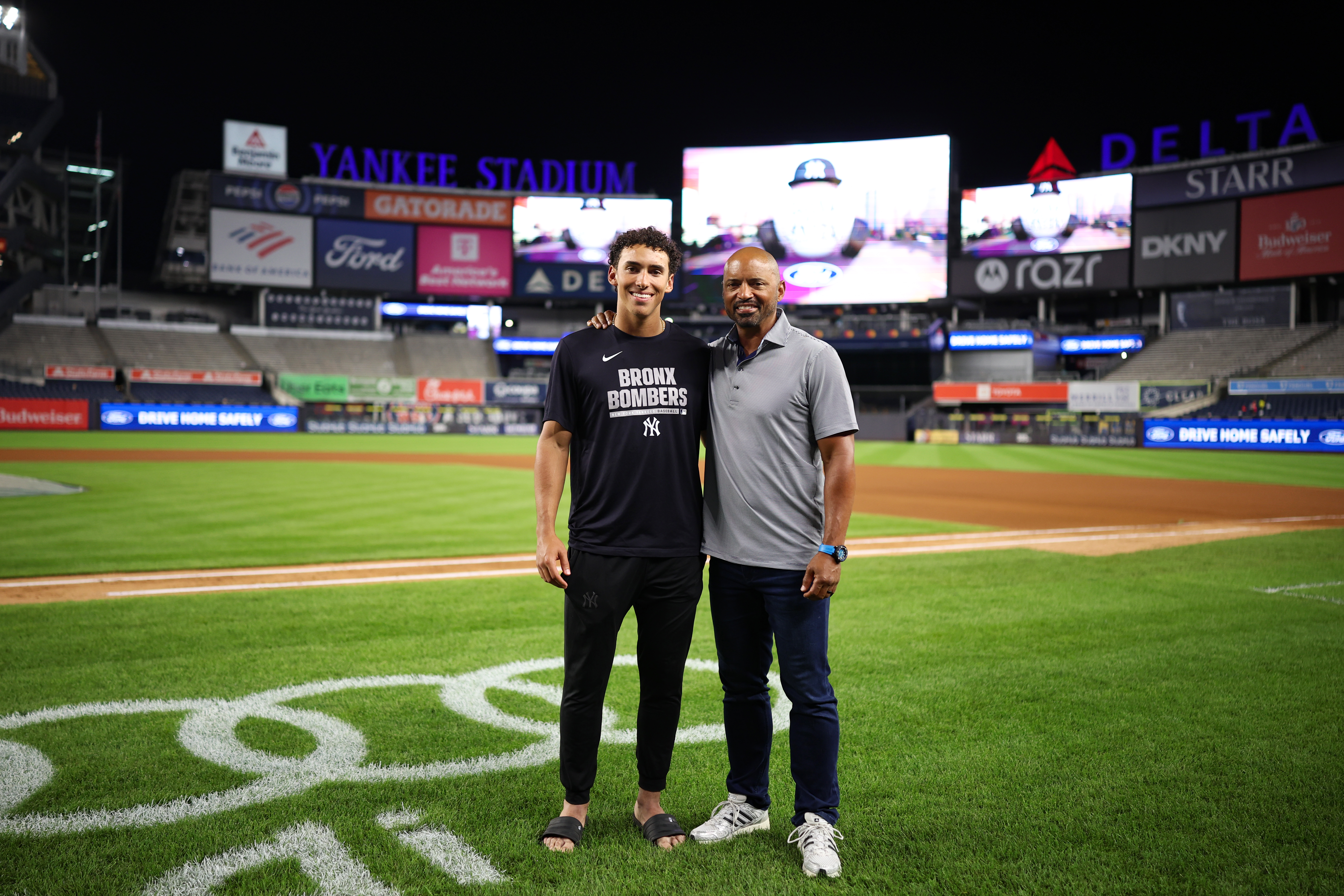 Like several others in the Yankees’ clubhouse, George Lombard Jr. (above, left) grew up in a baseball family, taught to love and excel at the sport from an early age. He followed his father, George Sr. (above, right), through various big league stops, then became a regular presence in clubhouses where his dad coached. The elder Lombard was on hand for George Jr.’s debut, which included a dramatic homer in his second career at-bat. (Photo Credit: New York Yankees)