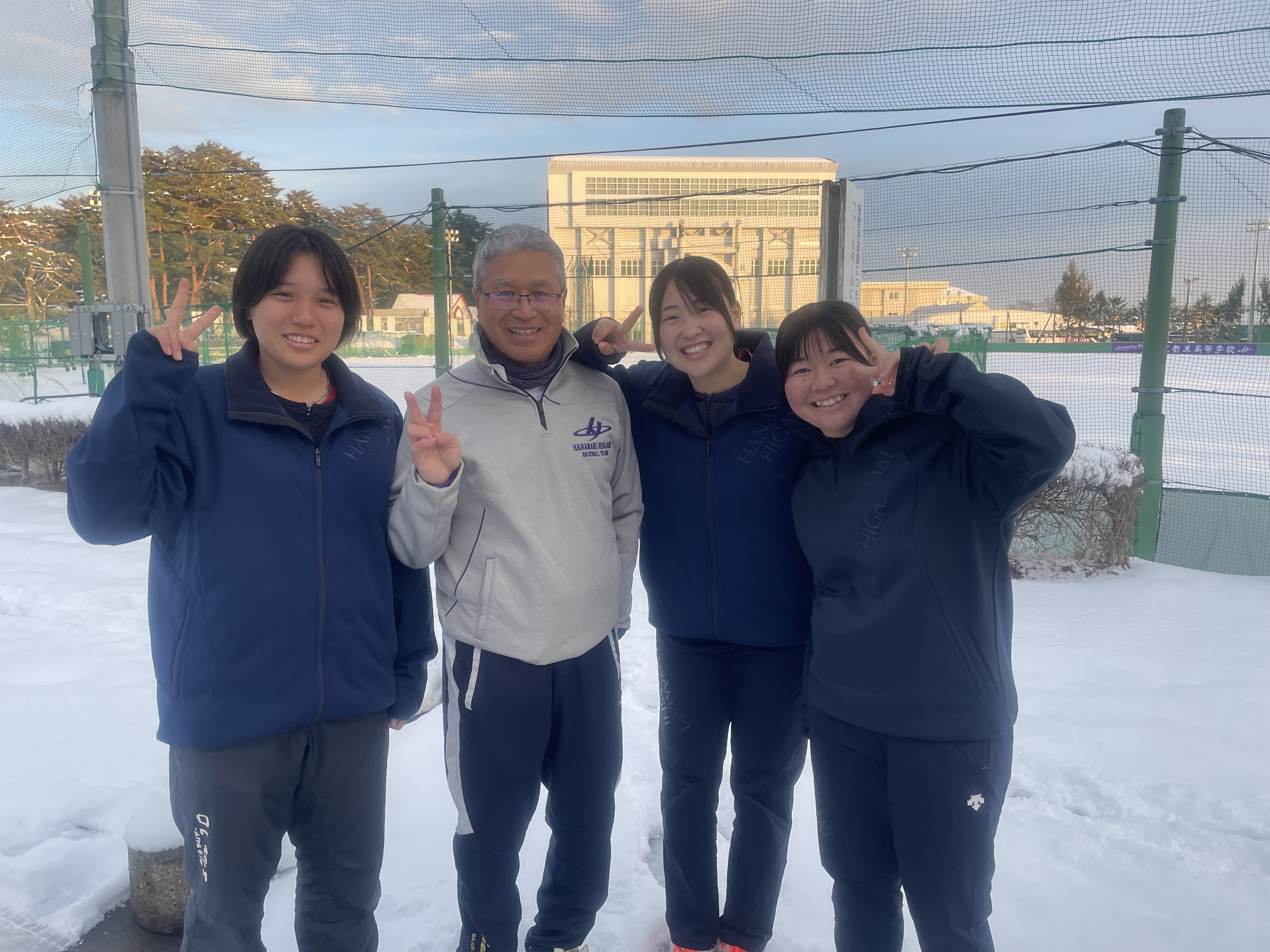 Hiroyuki Sasuga with some of the girls he coaches.