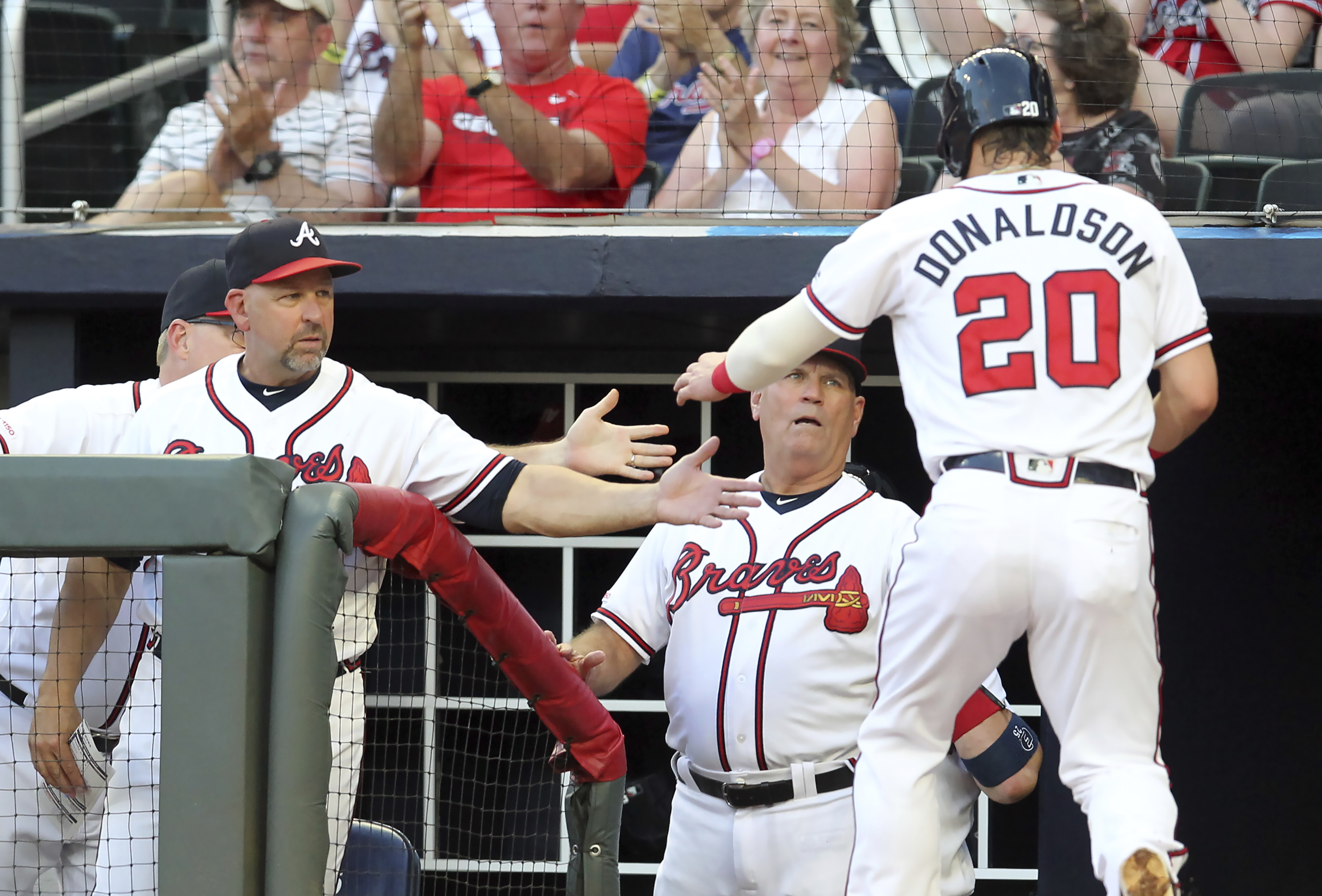 Weiss greets Donaldson in the Braves' dugout in 2019.