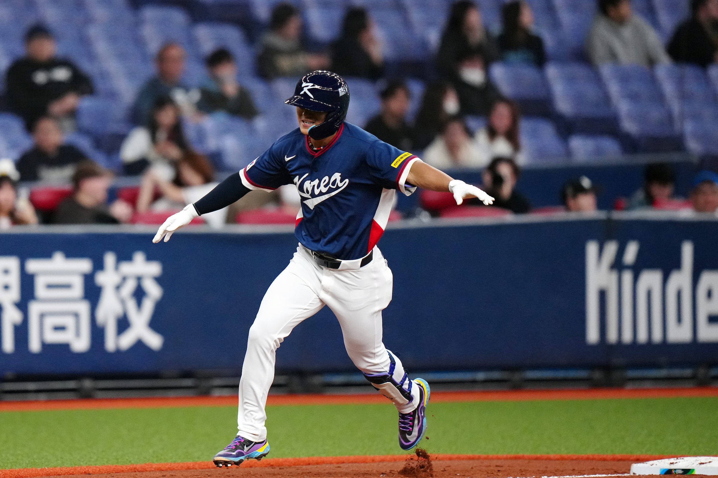 Do-yeong Kim celebrates as he rounds third base. Photo by Daniel Shirey.