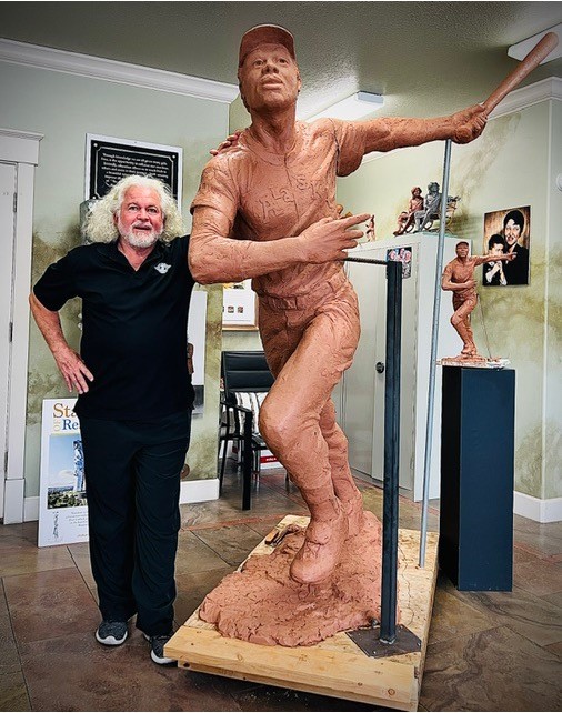 Sculptor Gary Lee Price with the clay version of the Dave Winfield statue.