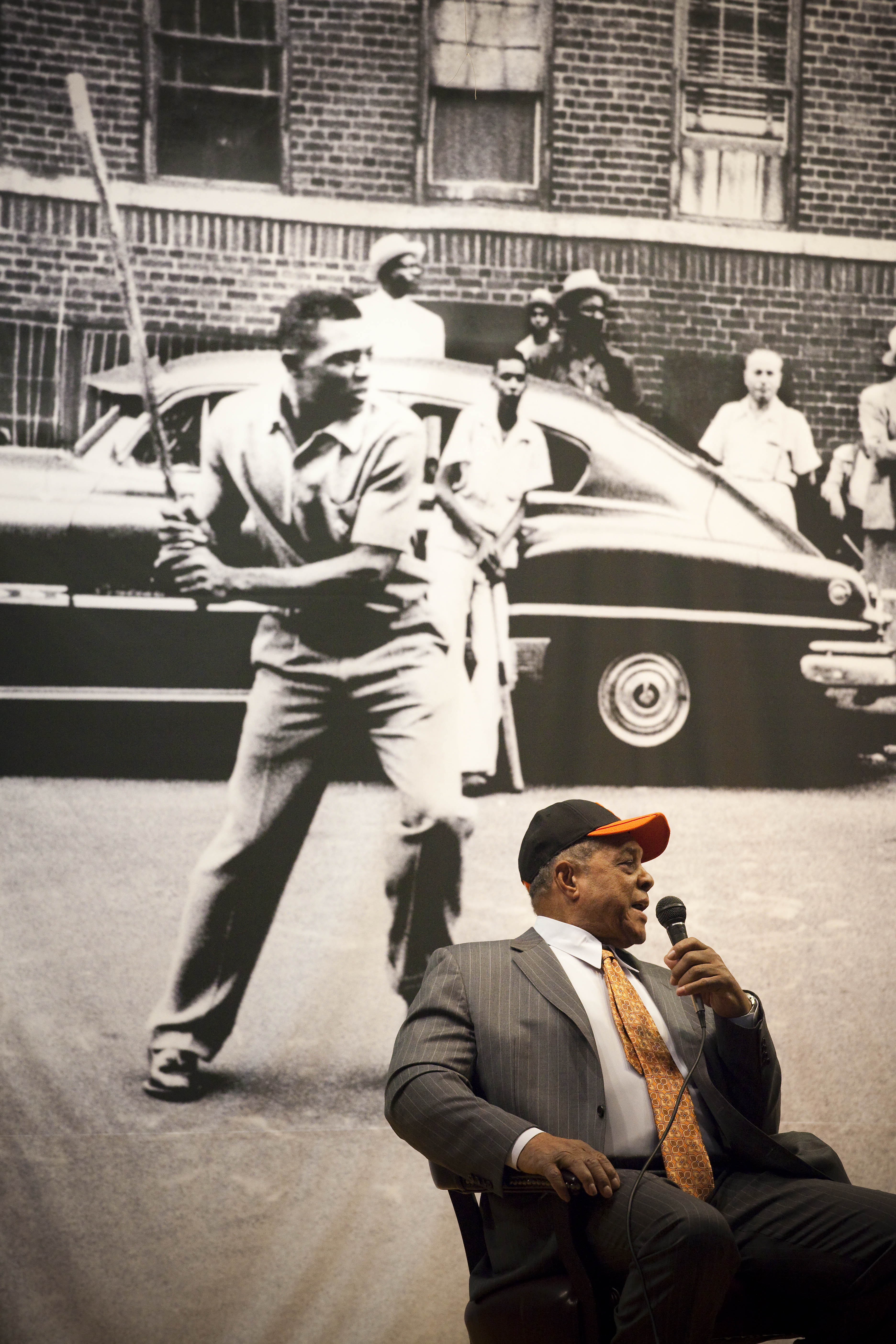 Willie Mays speaks in front of a famous photo of him playing stickball in Harlem (Getty Images, from 2011)