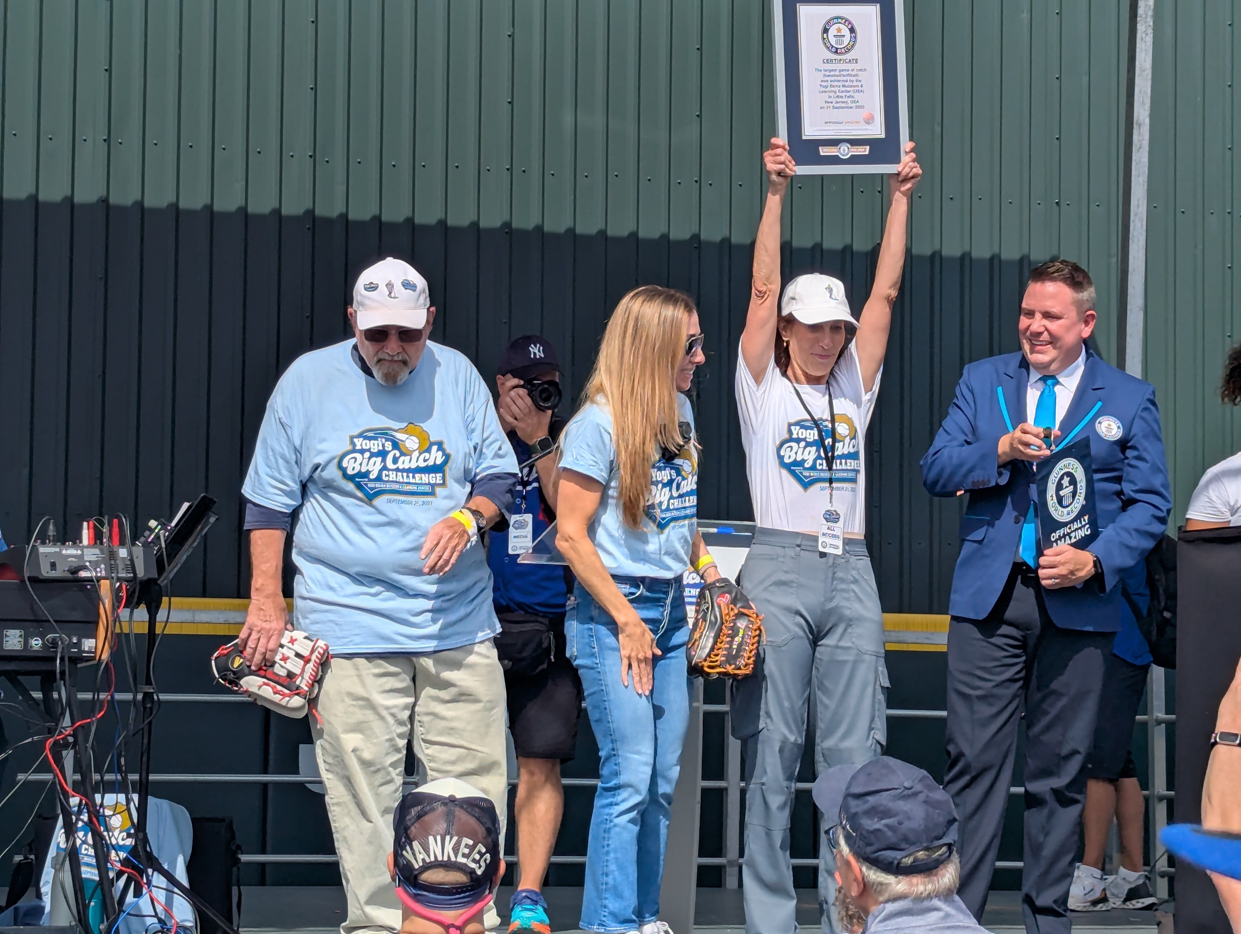 Eve Schaenen holds up the certificate from Guinness alongside (left to right) Larry Berra, Lindsay Berra and Guinness adjudicator Michael Empric.